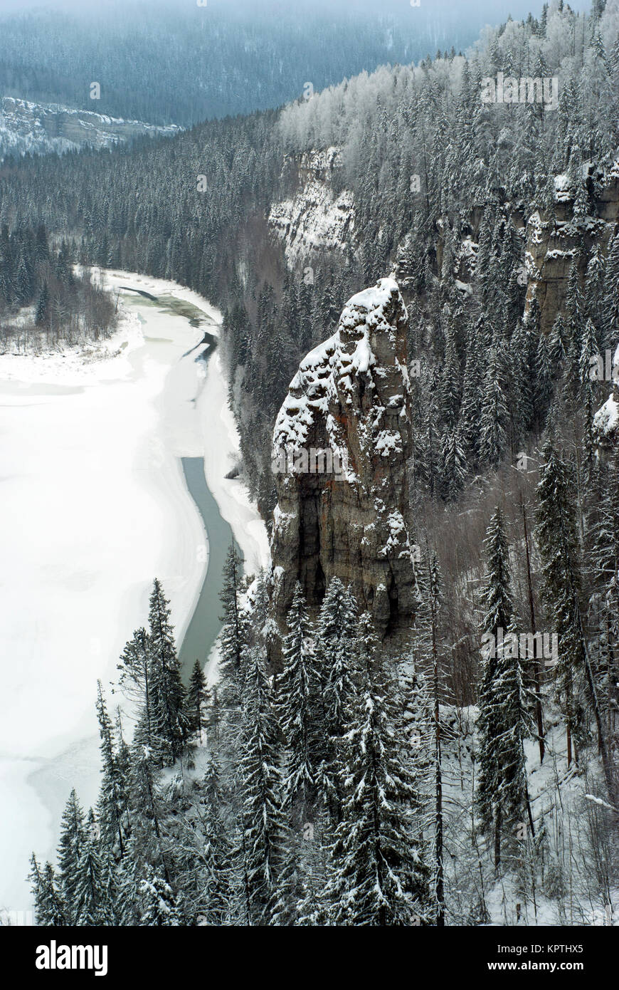 Winter view of the rock Devil`s Finger and the river Usva from the rock Stolby ('Pillars') in the Perm Krai, Ural, Russia Stock Photo